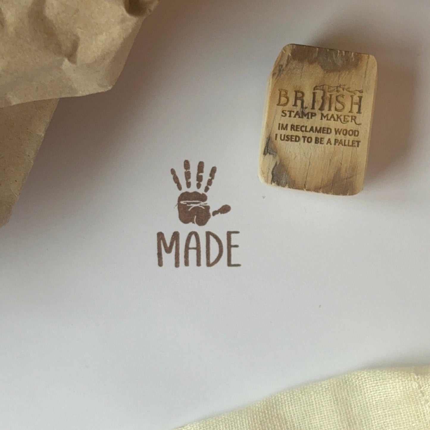 Hand made rubber stamp with a palm and the word made underneath.